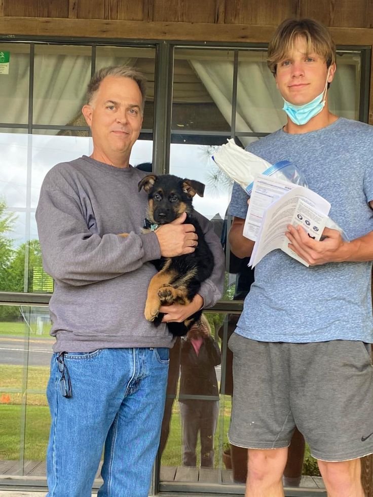 Happy family with their new German Shepherd puppy