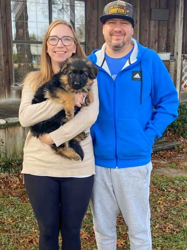 Happy family with their new German Shepherd puppy