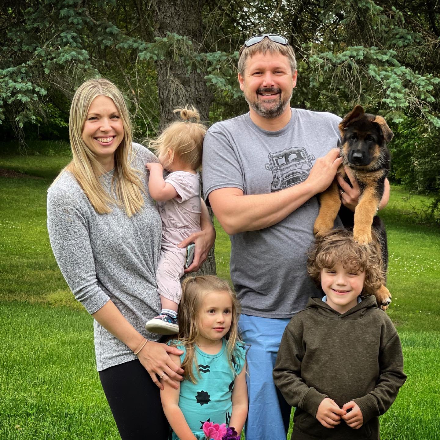 Happy family with their new German Shepherd puppy