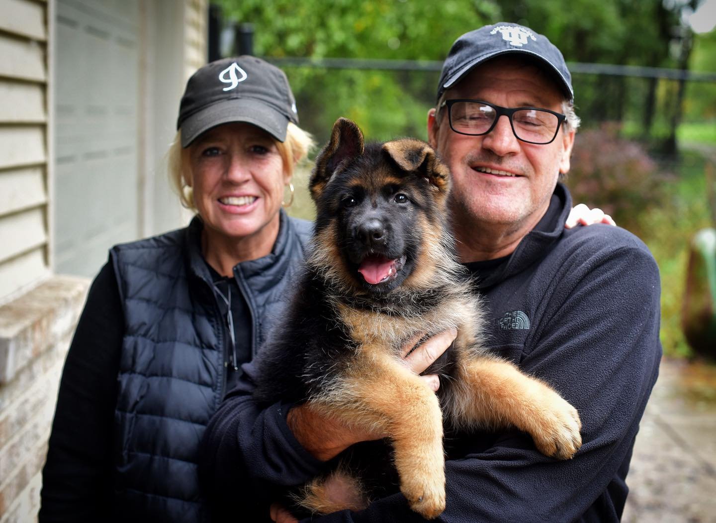 Happy family with their new German Shepherd puppy