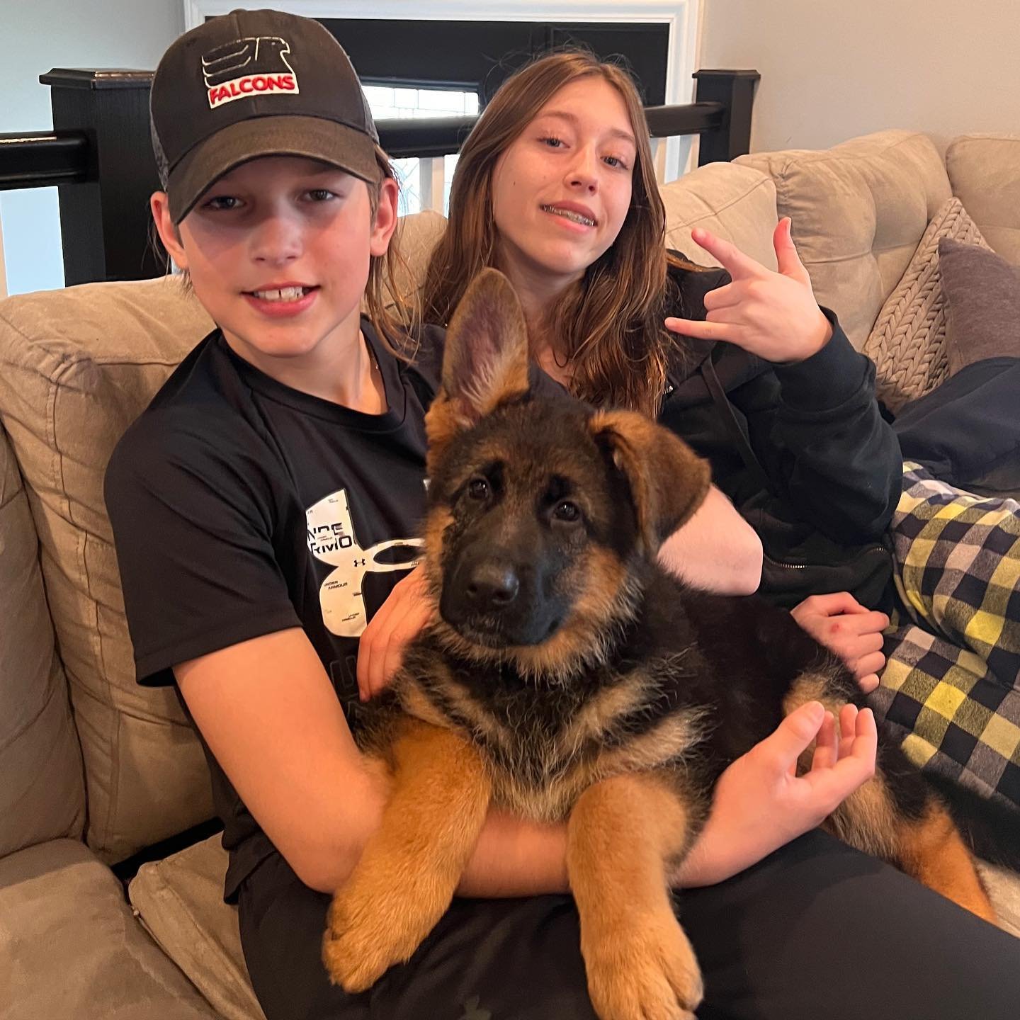 Happy family with their new German Shepherd puppy