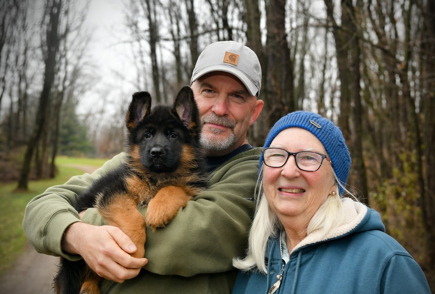 Happy family with their new German Shepherd puppy