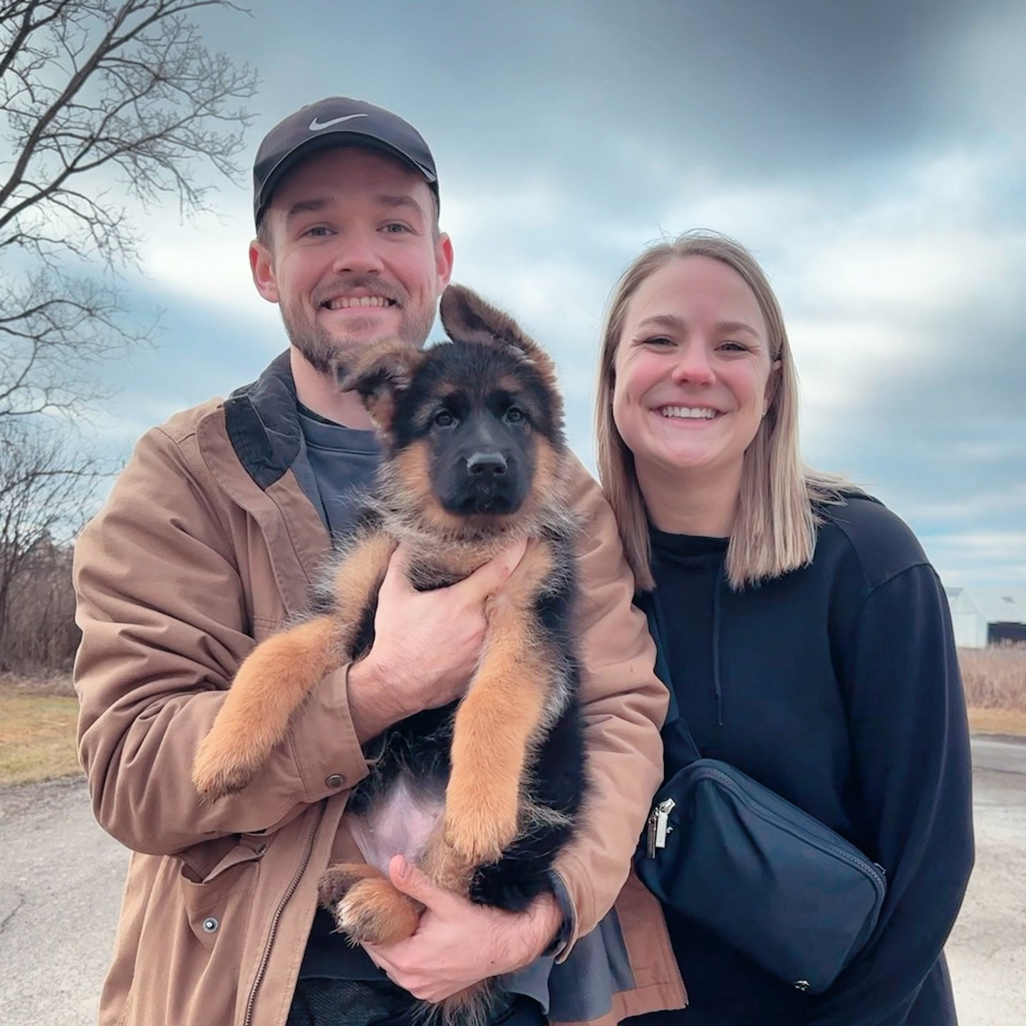 Happy family with their new German Shepherd puppy
