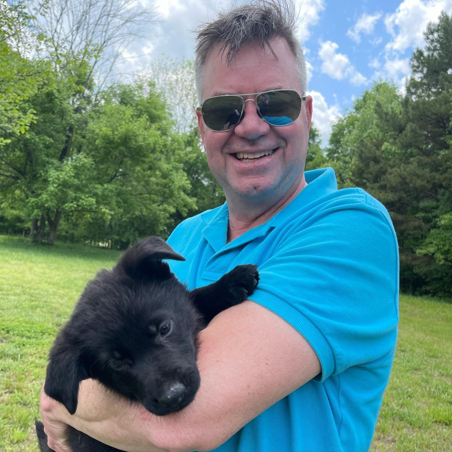 Happy family with their new German Shepherd puppy